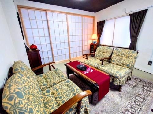a living room with a couch and a table at 酒と宿と不動産-yado- in Yokosuka