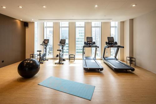 a gym with treadmills and a yoga ball on the floor at Solaria Nishitetsu Hotel Taipei Ximen in Taipei
