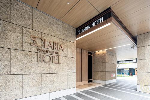 a building with a hotel sign on the side of it at Solaria Nishitetsu Hotel Taipei Ximen in Taipei