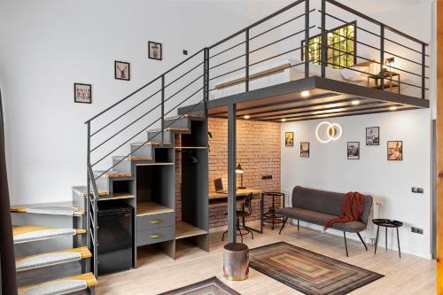 a loft apartment with a staircase and a dining room at 6Rooms in Sibiu