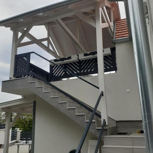 a spiral staircase on a building at Apartman for You in Gyenesdiás