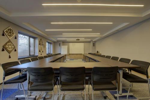 a conference room with a large table and chairs at My Hotel Bishkek in Bishkek