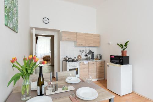 a kitchen with a table with plates on it at Prague - Karlin Apartments in Prague