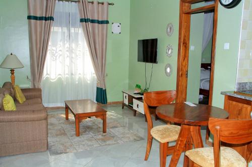 a living room with a couch and a table at Home Bliss Hotel- Fort portal Uganda in Fort Portal