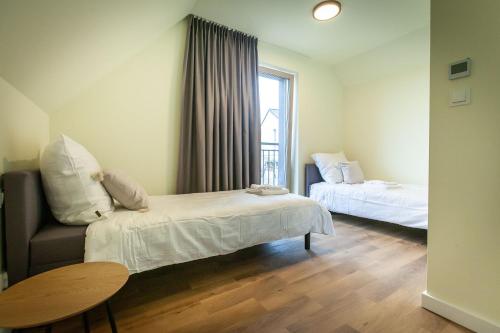 um quarto com duas camas, um sofá e uma mesa em EKO ZAKĄTEK em Ostre
