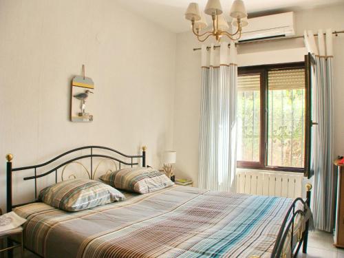 a bedroom with a bed and a window at Villa Alejandria in Moraira