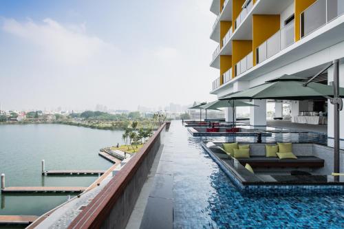a hotel swimming pool with a view of the water at Formosa Yacht Resort in Anping