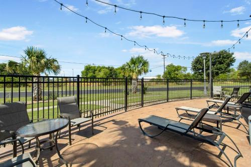 a group of chairs and tables in front of a fence at Holiday Inn Hotel & Suites Waco Northwest by IHG in Bellmead