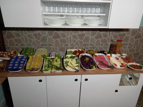 a counter with many plates and bowls of food at Emirhan Hotel & Sultanahmet in Istanbul