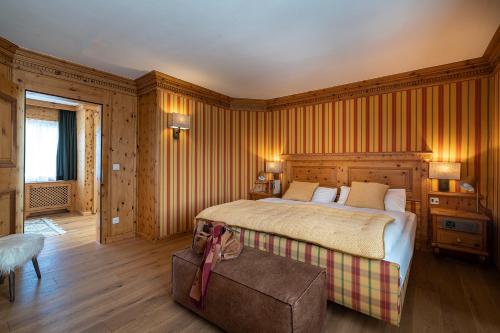 a bedroom with a bed and a couch in a room at Hotel Steffani in St. Moritz