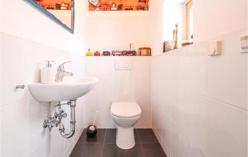 a white bathroom with a sink and a toilet at Awesome Home In Mhldorf With Sauna in Mühldorf