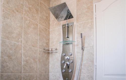 a shower with a shower head in a bathroom at Nice Home In Vailhauques With Wifi in Vailhauquès