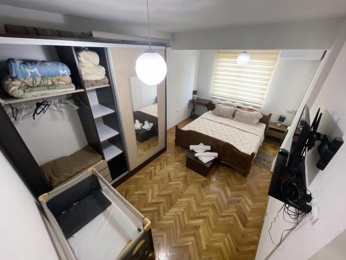 a small room with a bed and a mirror at Apartment Idea in Novi Pazar