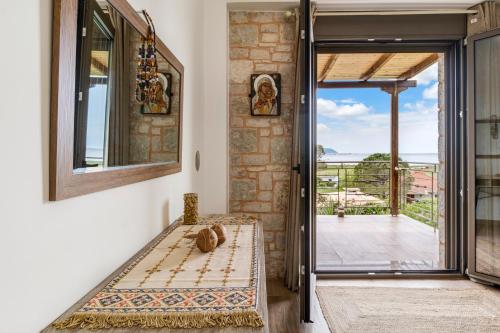 a room with a door leading to a balcony at Lefkada view villa Vasiliki 1 in Peratiá