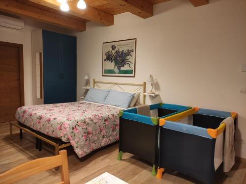 a bedroom with a bed and a blue cabinet at Casa Montefiore 13 LT nella tranquilla campagna Marchigiana in Ancona