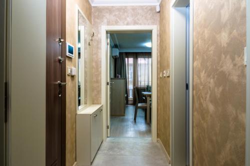 einen Flur mit einer Tür, die zu einem Esszimmer führt in der Unterkunft COOP Apartments, Sofia in Sofia