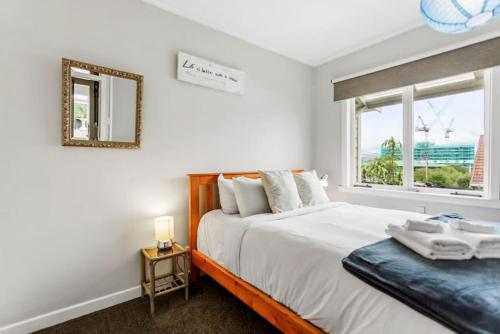 奧克蘭的住宿－Spacious Family Retreat in City - Netflix - WiFi，一间卧室设有一张大床和一个窗户。