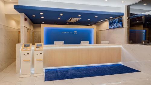a waiting area in a store with a blue wall at Toyoko Inn Kasukabe-eki Nishi-guchi in Kasukabe