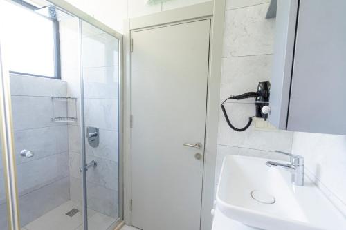 a bathroom with a shower and a sink at WEST HOUSE EXCLUSIVE HOTEL in Göcek