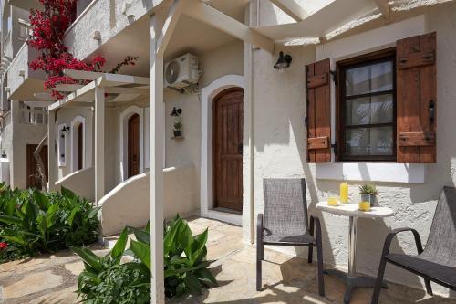 a patio of a house with chairs and a table at Mila Malia Studios Hotel in Malia