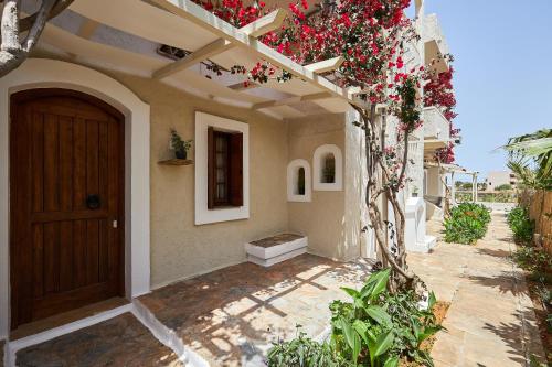 a front door of a house with flowers on it at Mila Malia Studios Hotel in Malia