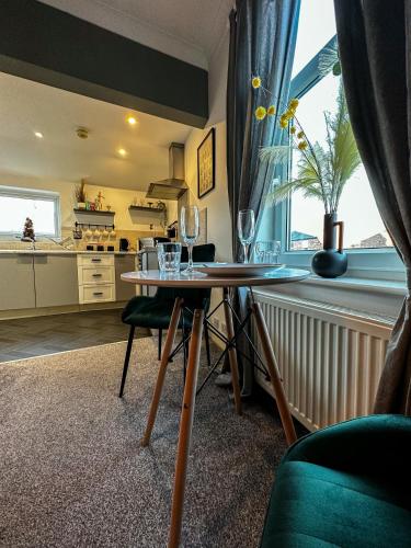 a kitchen with a table with wine glasses on it at Entire home/free parking /racecourse in York