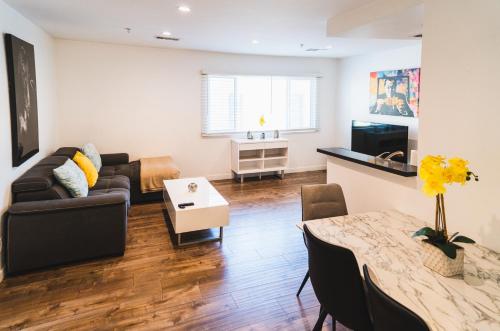 a living room with a couch and a table at Cozy Koreatown 1 Bedroom Modern Furnished Free Parking in Los Angeles