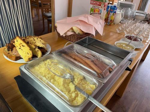 a table with a tray of food and a plate of bread at Penzion u Bláhů in Dolany