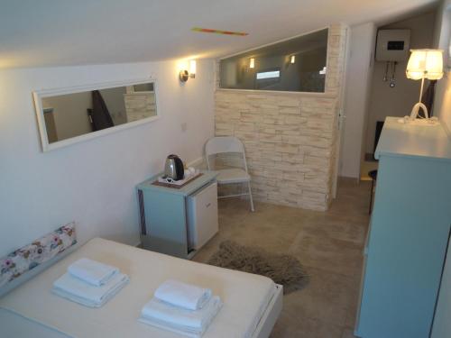 a room with a bed and a table with towels at Riva Brela SP-small loft in Brela