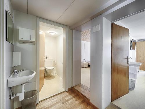 a bathroom with a sink and a toilet at Hotel Weisses Kreuz in St. Gallen