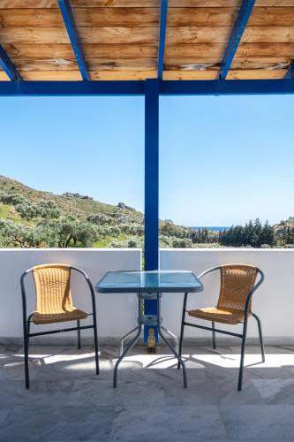 two chairs and a table on a patio at Anna Ageliki in Damnoni