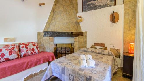 a living room with a bed and a fireplace at Cortijo la Era Castril by Ruralidays in Castril