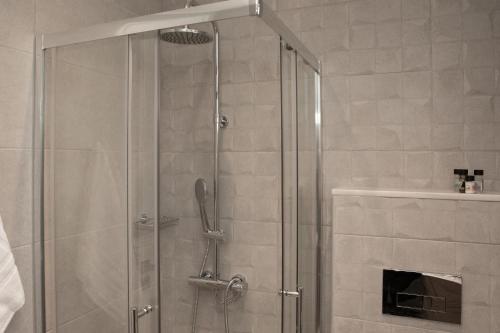 a shower with a glass door in a bathroom at Aegean Eyes 3bd House Βy the Sea in Kefalos