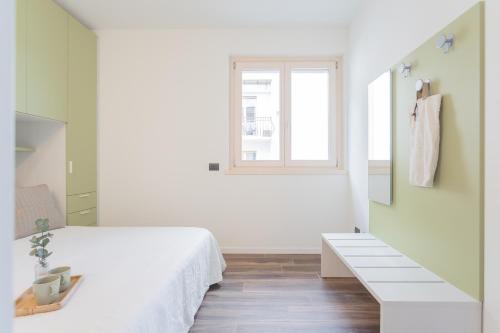 a white bedroom with a bed and a window at Misultin House & Swimming pool, Luxury in Lake Como by Rent All Como in Pianello Del Lario