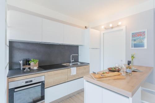 a kitchen with a sink and a counter top at Misultin House & Swimming pool, Luxury in Lake Como by Rent All Como in Pianello Del Lario