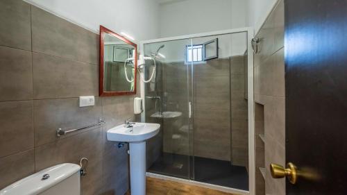 a bathroom with a glass shower and a sink at Parajes del Chanza Cortegana by Ruralidays in Cortegana