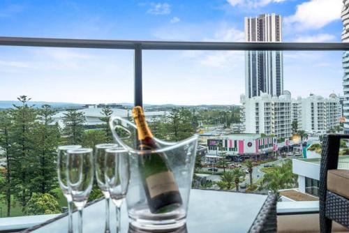 a bottle of champagne sitting on a table with wine glasses at Stunning 2 bed 2 bath 8th floor - GC Getaways in Gold Coast