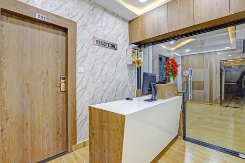 a lobby with a reception desk in a building at OYO Hotel R S Palace in Ahmedabad
