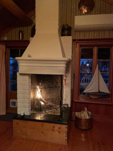 a fireplace in a living room with a fire place at Lake Lodge Rönnäs in Leksand