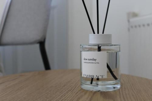 a glass vase with sticks in it on a table at Guesthouse at the Amstel river with 2BR 2BA and garden in Amstelveen