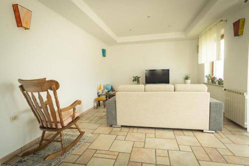 a living room with a couch and a chair at Apartment Ajdi in Ajdovščina