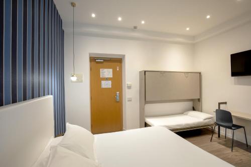 a hospital room with a bed and a mirror at Hotel La Scaletta in Lido di Ostia