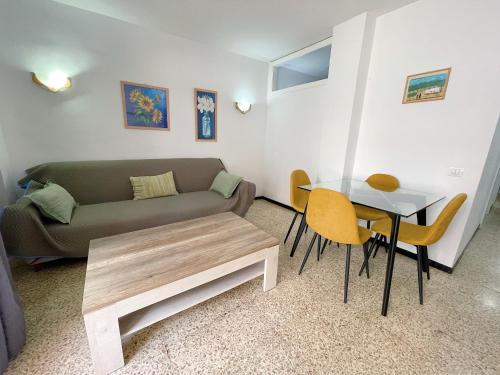 a living room with a couch and a table at Edificio Playa in Los Cristianos