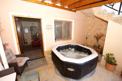 a large bath tub sitting in a room at Villa Makrades Deluxe in Makrádes