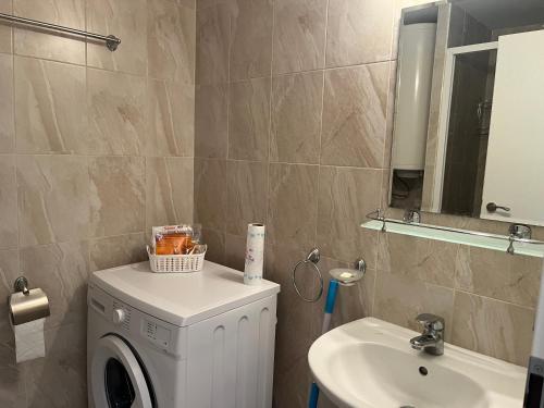 uma casa de banho com uma máquina de lavar roupa e um lavatório em Green Life Beach Resort Paradise Apartment em Sozopol