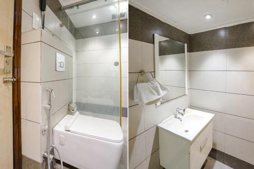 a bathroom with a toilet and a sink and a shower at FabHotel Grand Stay in New Delhi