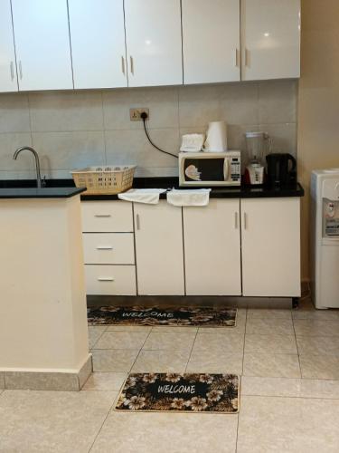 a kitchen with a counter with a microwave on it at Luxurious 2bedroom furnished apartment in Nairobi