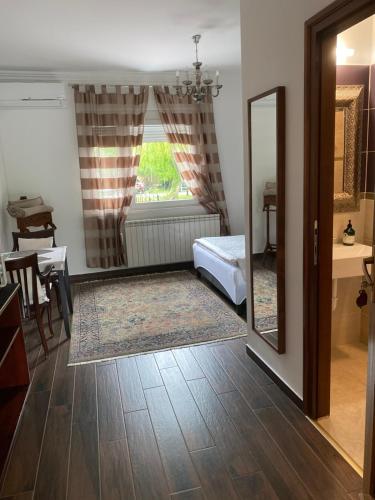 a living room with a mirror and a table at Helga Vendégház in Budaörs