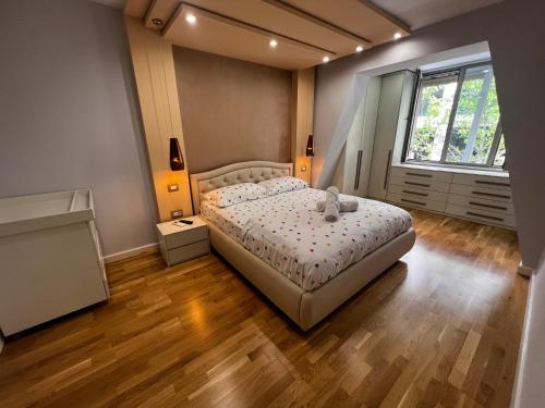 a bedroom with a bed with a teddy bear on it at Tirana center in Tirana