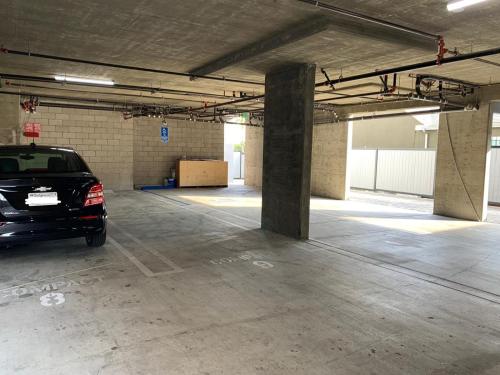 a parking garage with a car parked in it at Hollywood Loft Modern Style 1 Bedroom in Los Angeles